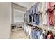 A fully outfitted walk-in closet offers storage for clothes and shoes at 2544 Ashley Rose Ter, Henderson, NV 89052