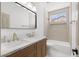 Bathroom with double sinks, wooden vanity, and shower-tub combination at 276 Glenridding St, Las Vegas, NV 89183