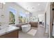 Bright bathroom featuring a soaking tub with neighborhood views at 276 Glenridding St, Las Vegas, NV 89183