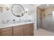 Luxurious bathroom with double sinks, marble countertops, and glass-enclosed shower at 276 Glenridding St, Las Vegas, NV 89183