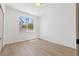 Minimalist bedroom with hardwood floors, white walls, and a bright window at 276 Glenridding St, Las Vegas, NV 89183