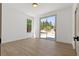 Minimalist bedroom with hardwood floors and sliding glass door to outside at 276 Glenridding St, Las Vegas, NV 89183