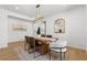 This dining room features a wooden table, patterned rug, and statement lighting at 276 Glenridding St, Las Vegas, NV 89183