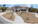 Beautiful two-story home with a well-manicured xeriscaped yard and circular driveway at 276 Glenridding St, Las Vegas, NV 89183