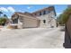 Side view of a two-story home with a three car garage and large driveway at 276 Glenridding St, Las Vegas, NV 89183