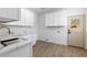 Bright laundry room with ample storage, modern countertop, and utility sink at 276 Glenridding St, Las Vegas, NV 89183