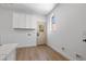 Bright laundry room with white cabinets and a view to the yard at 276 Glenridding St, Las Vegas, NV 89183