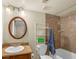 Bathroom with tub-shower combo, wooden vanity, and oval mirror at 3135 S Mojave Rd # 113, Las Vegas, NV 89121
