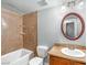Bathroom featuring shower-tub combo, wooden vanity and circular mirror at 3135 S Mojave Rd # 113, Las Vegas, NV 89121