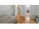 Bedroom featuring wood floors, closet, open bathroom and neutral paint at 3135 S Mojave Rd # 113, Las Vegas, NV 89121