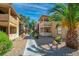 Building exteriors and landscaping with a concrete walkway path running through the complex at 3135 S Mojave Rd # 113, Las Vegas, NV 89121
