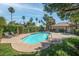 Sparkling community pool with mature landscaping, palm trees, and plenty of seating at 3135 S Mojave Rd # 113, Las Vegas, NV 89121