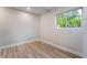 Cozy bedroom with new flooring and a bright window overlooking lush greenery at 3157 Faiss Dr, Las Vegas, NV 89134