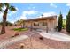 Charming home with a covered patio, desert landscaping, and a winding walkway at 3157 Faiss Dr, Las Vegas, NV 89134