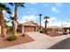 Attractive single-story home with desert landscaping, mature palm trees, and an attached garage at 3157 Faiss Dr, Las Vegas, NV 89134