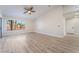 Spacious living room featuring wood-look floors and large windows with palm tree views at 3157 Faiss Dr, Las Vegas, NV 89134