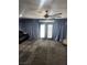 Large living area with unique carpet, ceiling fan, and sliding doors to patio at 324 Princeton St, Las Vegas, NV 89107