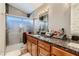 Bathroom showcasing a granite countertop vanity, framed shower door, and a modern mirror at 3355 Royal Bay Dr, Las Vegas, NV 89117