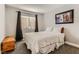 Bedroom features plush carpeting, a large window, and a bed with white comforter at 3355 Royal Bay Dr, Las Vegas, NV 89117
