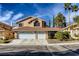 Charming two-story home with a red tile roof, three-car garage, and desert landscaping at 3355 Royal Bay Dr, Las Vegas, NV 89117