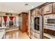 Modern kitchen with stainless steel appliances, light wood floor and large windows at 3355 Royal Bay Dr, Las Vegas, NV 89117