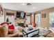 Comfortable living room featuring a stone fireplace, neutral walls, and a cozy sectional sofa at 3355 Royal Bay Dr, Las Vegas, NV 89117