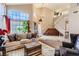 Open concept living room with a staircase and large windows bringing in natural light at 3355 Royal Bay Dr, Las Vegas, NV 89117
