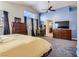 Bright main bedroom featuring large windows, plush carpet, and a ceiling fan for year-round comfort at 3355 Royal Bay Dr, Las Vegas, NV 89117