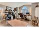 Home office with hardwood floors, custom shelves, and a desk with natural light from arched window at 3355 Royal Bay Dr, Las Vegas, NV 89117