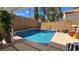 Backyard pool and patio area featuring a tanning deck and an inground spa with waterfall feature at 3355 Royal Bay Dr, Las Vegas, NV 89117