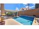 Beautiful pool with waterfall feature in a private backyard setting with covered patio area at 3355 Royal Bay Dr, Las Vegas, NV 89117