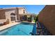 Backyard pool and covered patio area offering comfortable seating and desert landscaping at 3355 Royal Bay Dr, Las Vegas, NV 89117
