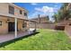 Spacious backyard featuring lush green grass and a covered patio for relaxing outdoors at 353 Templeton Dr, Henderson, NV 89074