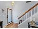 Entryway featuring a decorative front door, staircase, and hardwood floors at 353 Templeton Dr, Henderson, NV 89074