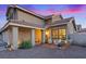 Charming home featuring a welcoming front porch with comfortable seating amidst the manicured landscaping at 353 Templeton Dr, Henderson, NV 89074