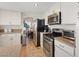 Bright kitchen with white cabinets, granite countertops, and stainless steel appliances at 353 Templeton Dr, Henderson, NV 89074