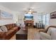 Cozy living room features a brick fireplace, hardwood floors, and comfortable seating at 353 Templeton Dr, Henderson, NV 89074
