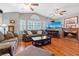 Bright living room featuring a brick fireplace, wood floors, and vaulted ceilings at 353 Templeton Dr, Henderson, NV 89074