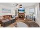 Inviting living room with a leather sectional sofa, brick fireplace, and ceiling fan at 353 Templeton Dr, Henderson, NV 89074