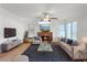 Comfortable living room featuring a fireplace, ceiling fan, and neutral colors at 353 Templeton Dr, Henderson, NV 89074