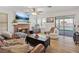 Warm living room with brick fireplace, hardwood floors, and sliding glass doors to the backyard at 353 Templeton Dr, Henderson, NV 89074