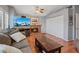 Living room with a brick fireplace, wood floors, and a sliding closet at 353 Templeton Dr, Henderson, NV 89074