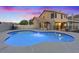 Backyard with swimming pool and hardscape, with home exterior visible in the background at 353 Templeton Dr, Henderson, NV 89074
