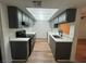 Updated kitchen features gray cabinets, quartz countertops and modern appliances at 3585 Arville St # 403A, Las Vegas, NV 89103