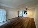 Open living area with wood-look flooring, ceiling fan, and view to kitchen through pass-through at 3585 Arville St # 403A, Las Vegas, NV 89103