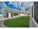 Backyard with artificial turf and gravel featuring a covered patio perfect for outdoor entertaining at 3630 Tobias Ln, Las Vegas, NV 89120