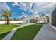 A backyard featuring green artificial turf, a pool, and palm trees creates a stunning outdoor oasis at 3630 Tobias Ln, Las Vegas, NV 89120