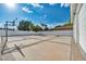 Sunlit basketball court featuring a hoop, concrete surface, and a surrounding fence at 3630 Tobias Ln, Las Vegas, NV 89120