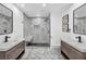 Elegant bathroom featuring dual vanities, a marble-tiled shower, and modern fixtures at 3630 Tobias Ln, Las Vegas, NV 89120