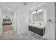 Modern bathroom boasts double vanity with backlit mirror and stylish marble floors at 3630 Tobias Ln, Las Vegas, NV 89120